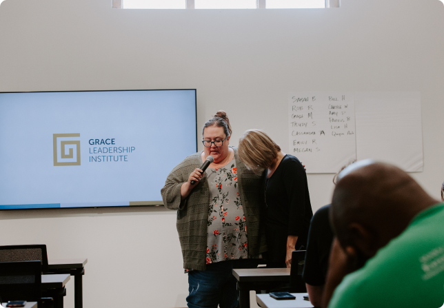 RF3A4549 1 Two females speaking in front of a class